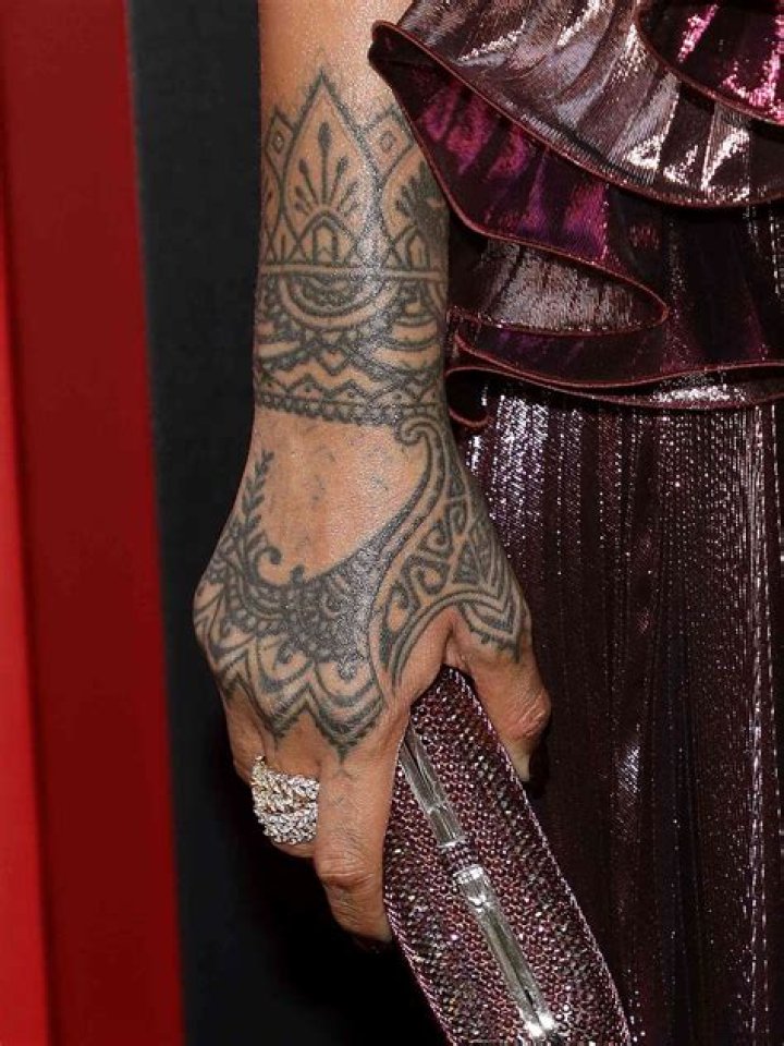 What do rihannas tattoos say?